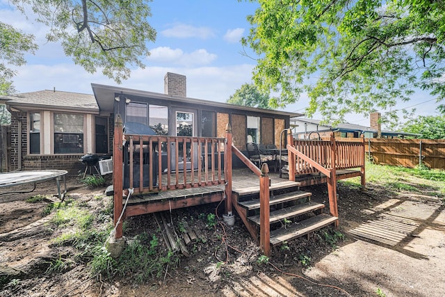 3811 Pelham Mnr, Arlington, TX 76016 - rear view of house with a chimney, a wooden deck, and fence