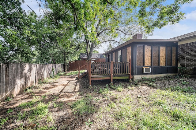 3811 Pelham Mnr, Arlington, TX 76016 - view of yard featuring a wooden deck, a sunroom, and a fenced backyard