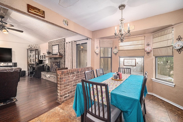 3811 Pelham Mnr, Arlington, TX 76016 - dining room featuring ceiling fan with notable chandelier, a textured ceiling, baseboards, a textured wall, and vaulted ceiling