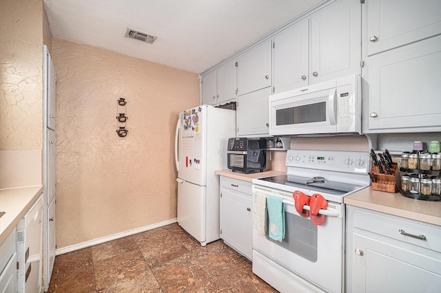 3811 Pelham Mnr, Arlington, TX 76016 - kitchen featuring white appliances, visible vents, a textured wall, light countertops, and baseboards