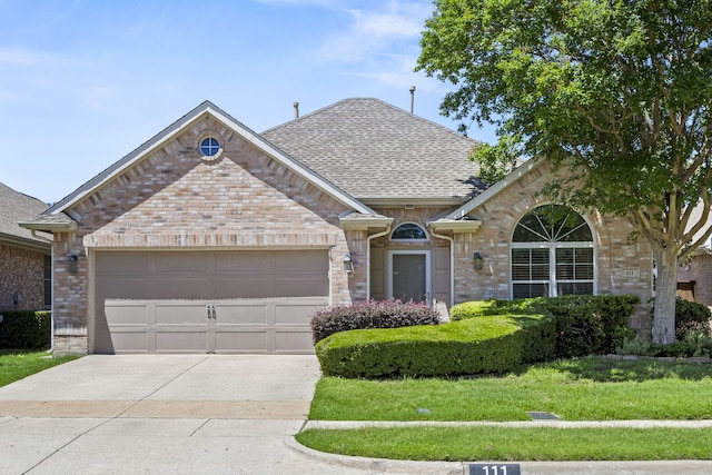 111 Stonecreek Dr, Irving, TX 75063 - french provincial home with driveway, brick siding, roof with shingles, and a garage