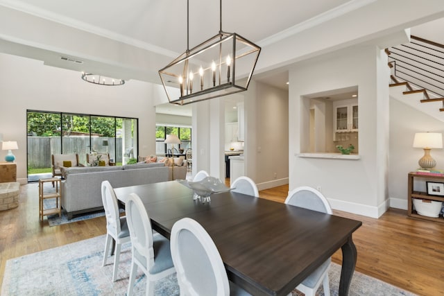 431 Blanning Dr, Dallas, TX 75218 - dining room with stairs, an inviting chandelier, visible vents, and wood finished floors