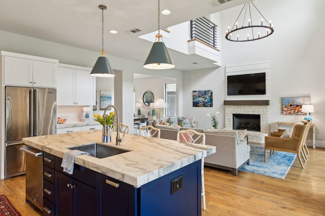 431 Blanning Dr, Dallas, TX 75218 - kitchen featuring a sink, high end fridge, visible vents, white cabinetry, and open floor plan
