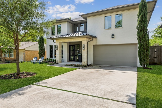 431 Blanning Dr, Dallas, TX 75218 - view of front of house featuring brick siding, concrete driveway, a garage, a front yard, and a standing seam roof