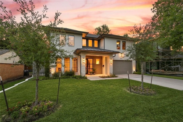 431 Blanning Dr, Dallas, TX 75218 - prairie-style house with concrete driveway, an attached garage, a front lawn, and a standing seam roof