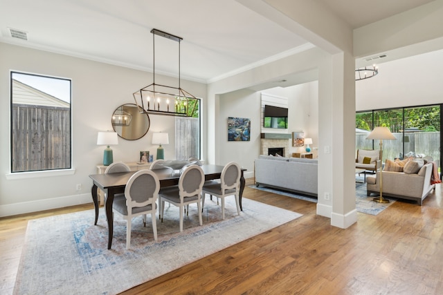 431 Blanning Dr, Dallas, TX 75218 - dining space featuring a chandelier, visible vents, and a fireplace