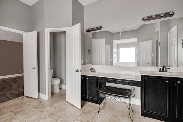 1001 Benjamin Dr, Burleson, TX 76028 - bathroom featuring toilet, double vanity, and a sink