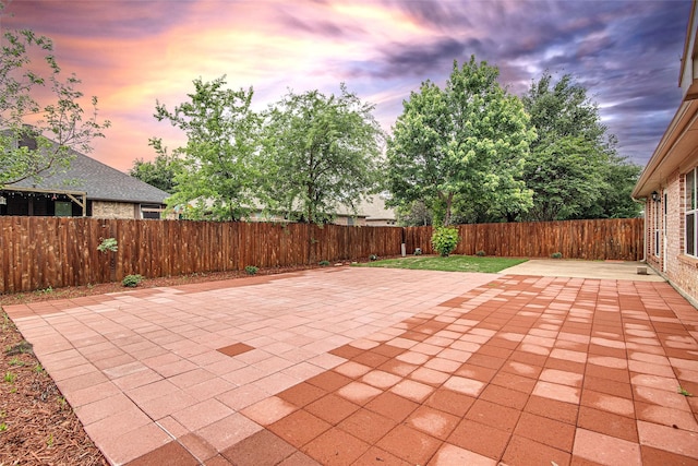 1001 Benjamin Dr, Burleson, TX 76028 - patio terrace at dusk featuring a fenced backyard