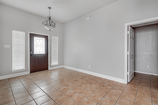 1001 Benjamin Dr, Burleson, TX 76028 - foyer entrance with baseboards and light tile patterned flooring