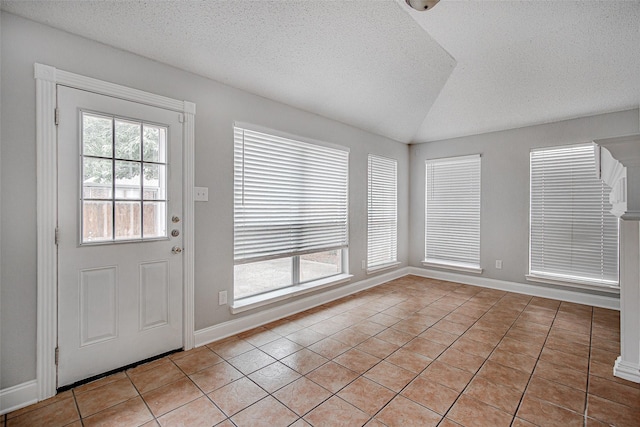 1001 Benjamin Dr, Burleson, TX 76028 - interior space featuring light tile patterned floors, vaulted ceiling, baseboards, and a textured ceiling