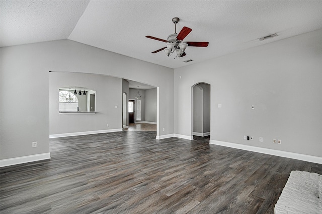 1001 Benjamin Dr, Burleson, TX 76028 - unfurnished living room featuring a ceiling fan, a textured ceiling, dark wood finished floors, visible vents, and arched walkways