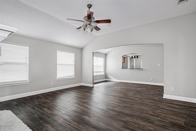 1001 Benjamin Dr, Burleson, TX 76028 - unfurnished living room with vaulted ceiling, a textured ceiling, baseboards, ceiling fan, and wood finished floors