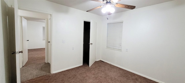 unfurnished bedroom featuring carpet, baseboards, a ceiling fan, and a closet