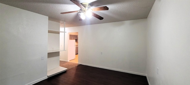 spare room featuring baseboards, ceiling fan, a textured ceiling, and wood finished floors