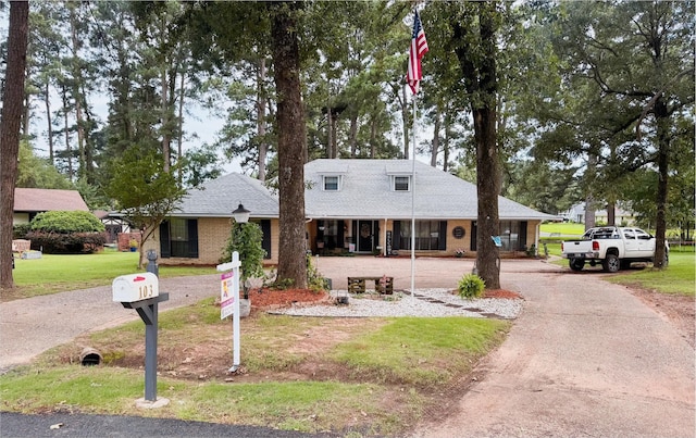 103 Maple Leaf Ln, Haughton, LA 71037 - view of front of home featuring a front lawn, driveway, brick siding, and roof with shingles