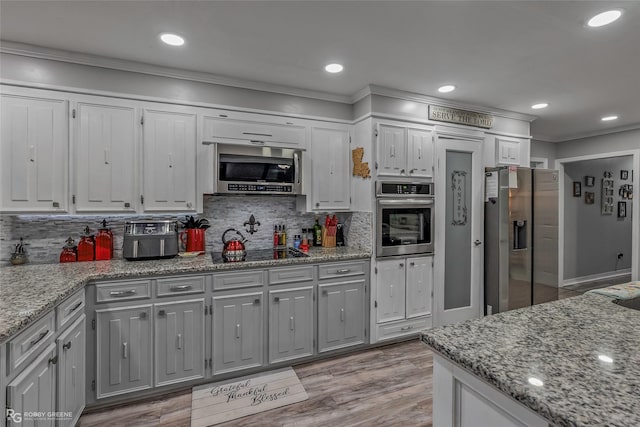 103 Maple Leaf Ln, Haughton, LA 71037 - kitchen featuring white cabinets, crown molding, appliances with stainless steel finishes, and tasteful backsplash