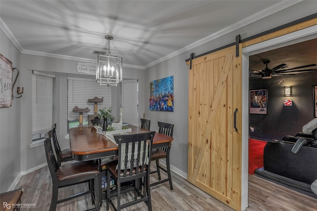 103 Maple Leaf Ln, Haughton, LA 71037 - dining area with ornamental molding, a barn door, baseboards, and wood finished floors