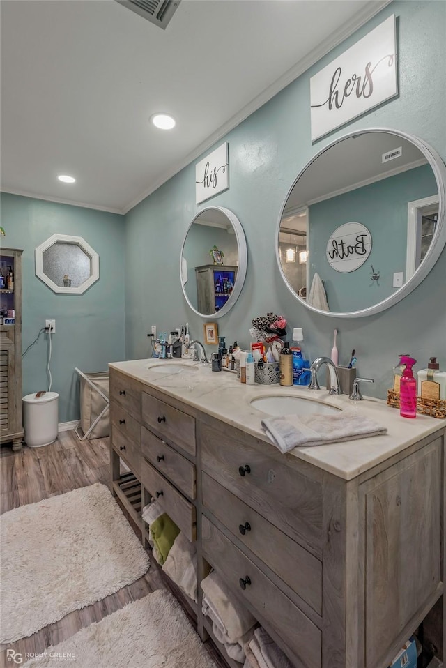 103 Maple Leaf Ln, Haughton, LA 71037 - full bathroom featuring double vanity, wood finished floors, a sink, visible vents, and ornamental molding