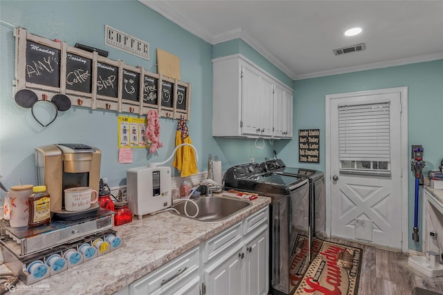 103 Maple Leaf Ln, Haughton, LA 71037 - washroom with cabinet space, independent washer and dryer, wood finished floors, visible vents, and crown molding