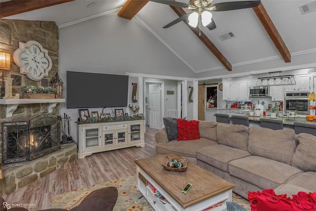 103 Maple Leaf Ln, Haughton, LA 71037 - living room featuring beam ceiling, visible vents, light wood-style flooring, and a ceiling fan