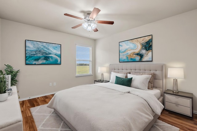 bedroom featuring baseboards, a ceiling fan, and wood finished floors