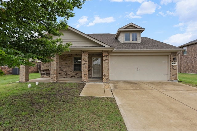 view of front of home featuring a front lawn, concrete driveway, brick siding, and a garage