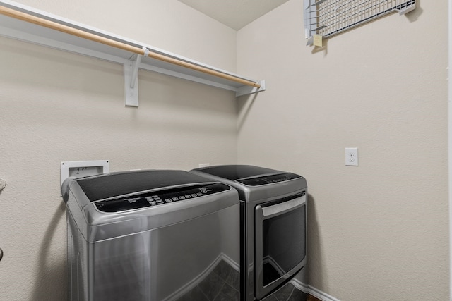 laundry area featuring baseboards, washing machine and dryer, and laundry area