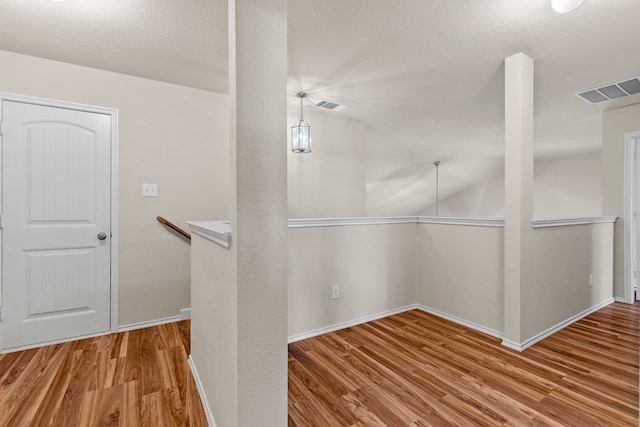 spacious closet featuring visible vents and wood finished floors