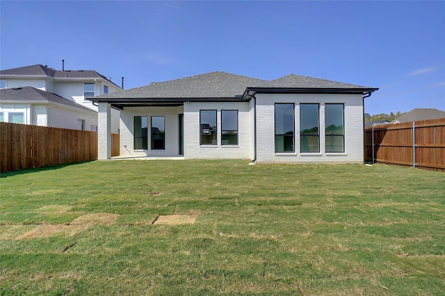 629 Hummingbird Dr, Aledo, TX 76008 - rear view of house featuring a yard, brick siding, a shingled roof, and a fenced backyard