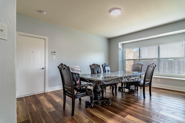 dining area featuring baseboards and wood finished floors