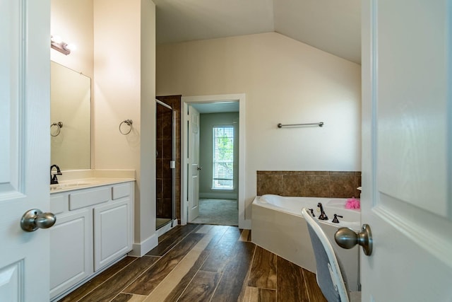 full bathroom featuring a bath, vanity, wood finished floors, and a shower stall