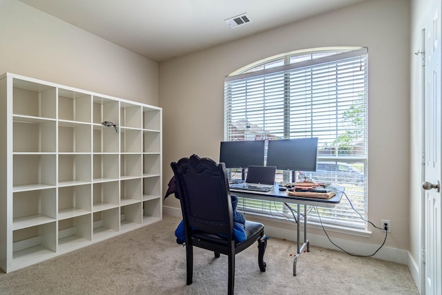 carpeted office space with plenty of natural light and baseboards