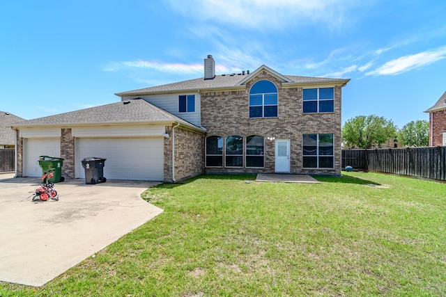 view of front of house with driveway, brick siding, fence, an attached garage, and a front lawn
