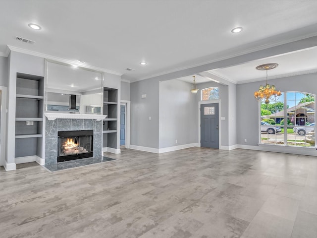 unfurnished living room with crown molding, a high end fireplace, healthy amount of natural light, baseboards, and a chandelier
