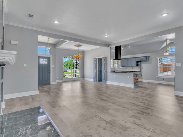 unfurnished living room featuring crown molding, baseboards, ceiling fan, a chandelier, and recessed lighting