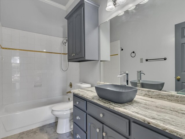 full bathroom with ornamental molding, vanity, toilet, and shower / washtub combination