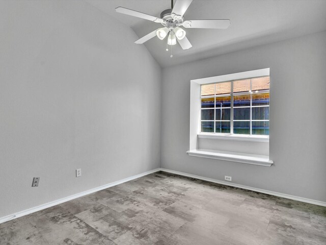 empty room featuring vaulted ceiling, a ceiling fan, and baseboards