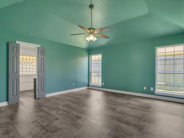 unfurnished room featuring a ceiling fan, plenty of natural light, and baseboards