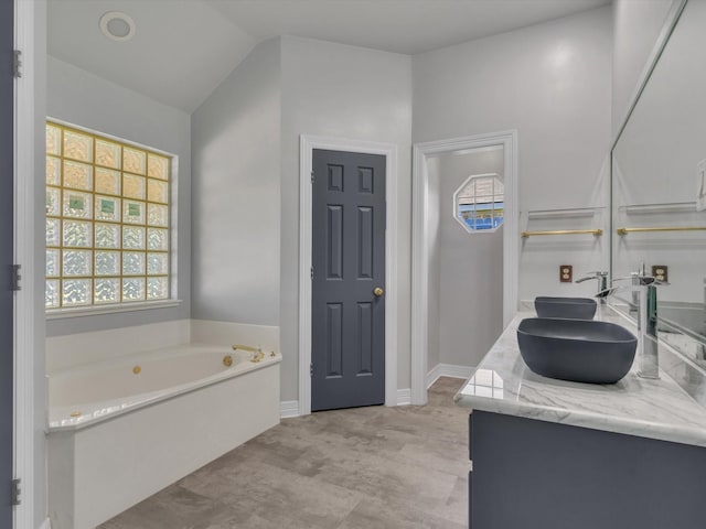 bathroom featuring a bath and double vanity