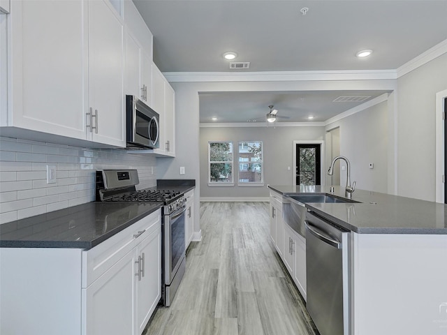 3356 Norris St, Plano, TX 75074 - kitchen featuring a sink, crown molding, visible vents, and appliances with stainless steel finishes