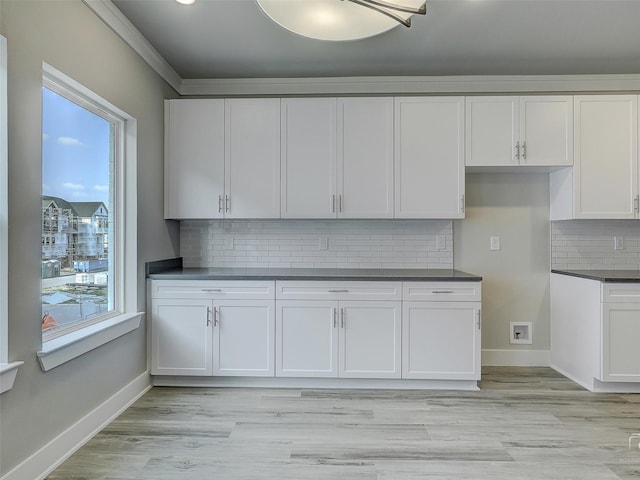 3356 Norris St, Plano, TX 75074 - kitchen featuring white cabinetry, dark countertops, decorative backsplash, and baseboards