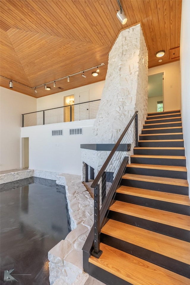 718 Byrd Dr, Abilene, TX 79601 - staircase with a fireplace, wood ceiling, track lighting, and lofted ceiling