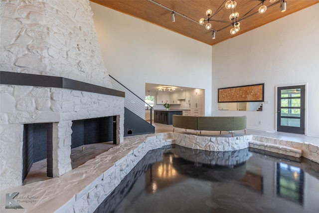 718 Byrd Dr, Abilene, TX 79601 - reception area with high vaulted ceiling, wood ceiling, a fireplace, and a chandelier