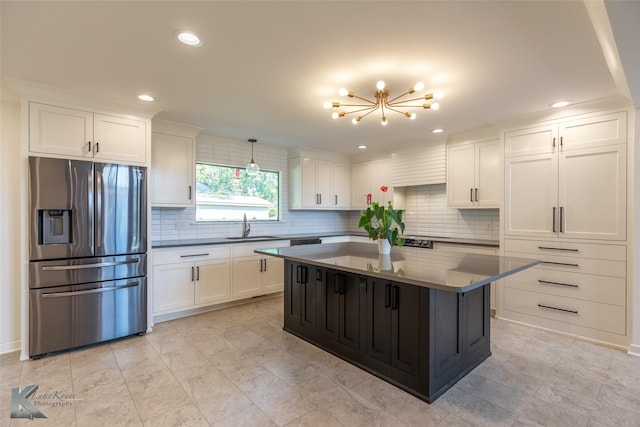 718 Byrd Dr, Abilene, TX 79601 - kitchen with stainless steel fridge with ice dispenser, a chandelier, white cabinets, tasteful backsplash, and a sink