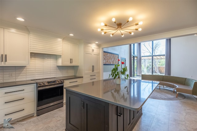 718 Byrd Dr, Abilene, TX 79601 - kitchen featuring stainless steel electric range, a chandelier, tasteful backsplash, white cabinets, and a kitchen island