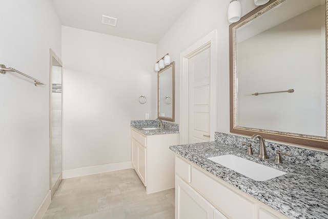 313 Featherstone Trl, Wylie, TX 75098 - full bathroom with baseboards, visible vents, two vanities, and a sink