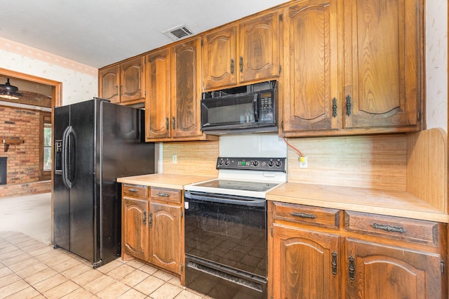 107 Russell Dr, Highland Village, TX 75077 - kitchen featuring black appliances, wallpapered walls, light countertops, tasteful backsplash, and brown cabinets