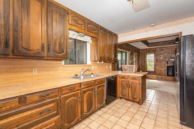 107 Russell Dr, Highland Village, TX 75077 - kitchen with black appliances, wallpapered walls, a sink, a peninsula, and light countertops