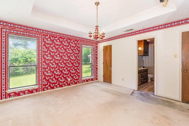 107 Russell Dr, Highland Village, TX 75077 - carpeted spare room with a chandelier, a raised ceiling, healthy amount of natural light, and wallpapered walls