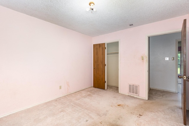 107 Russell Dr, Highland Village, TX 75077 - unfurnished bedroom with carpet, a closet, and a textured ceiling